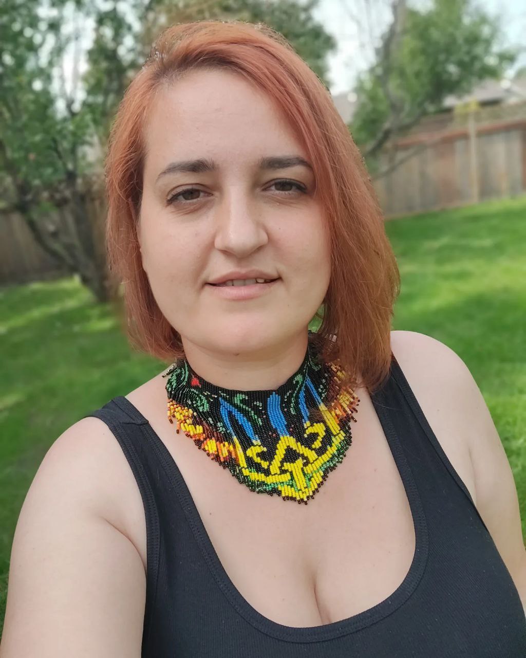 Model wearing sunflower Tryzub beaded necklac