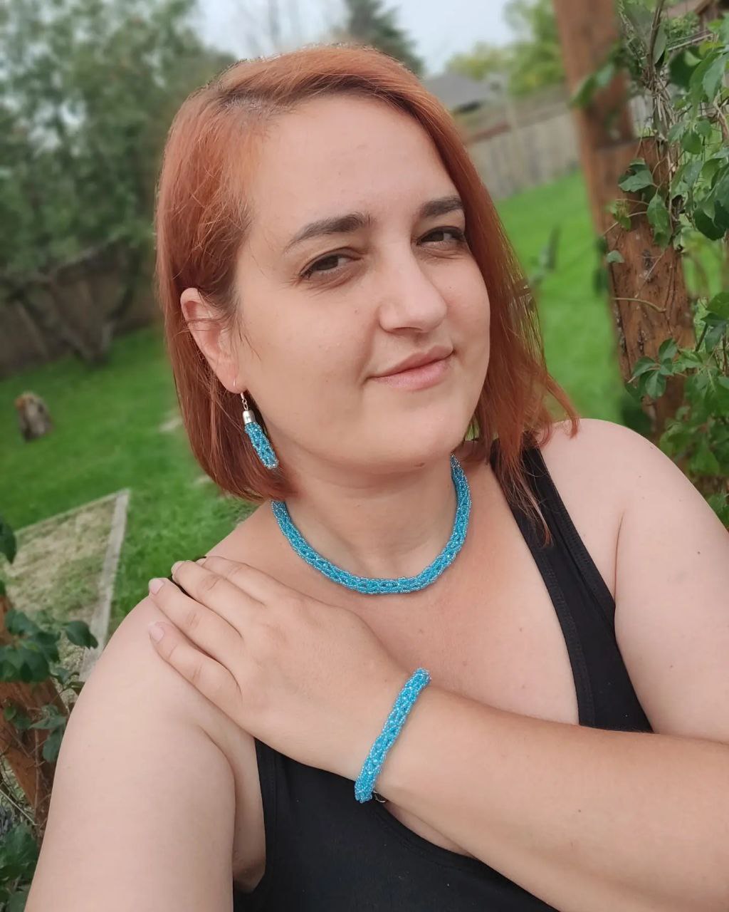 Model wearing turquoise beaded necklace, bracelet and earrings — handmade in Canada