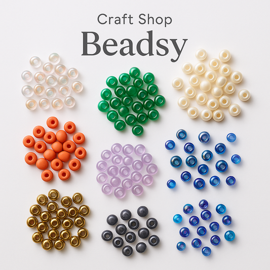 Various types of seed beads in different finishes and colors, including iridescent, matte, glossy, pearl, metallic, and translucent, neatly arranged on a white background. Craft Shop Beadsy.