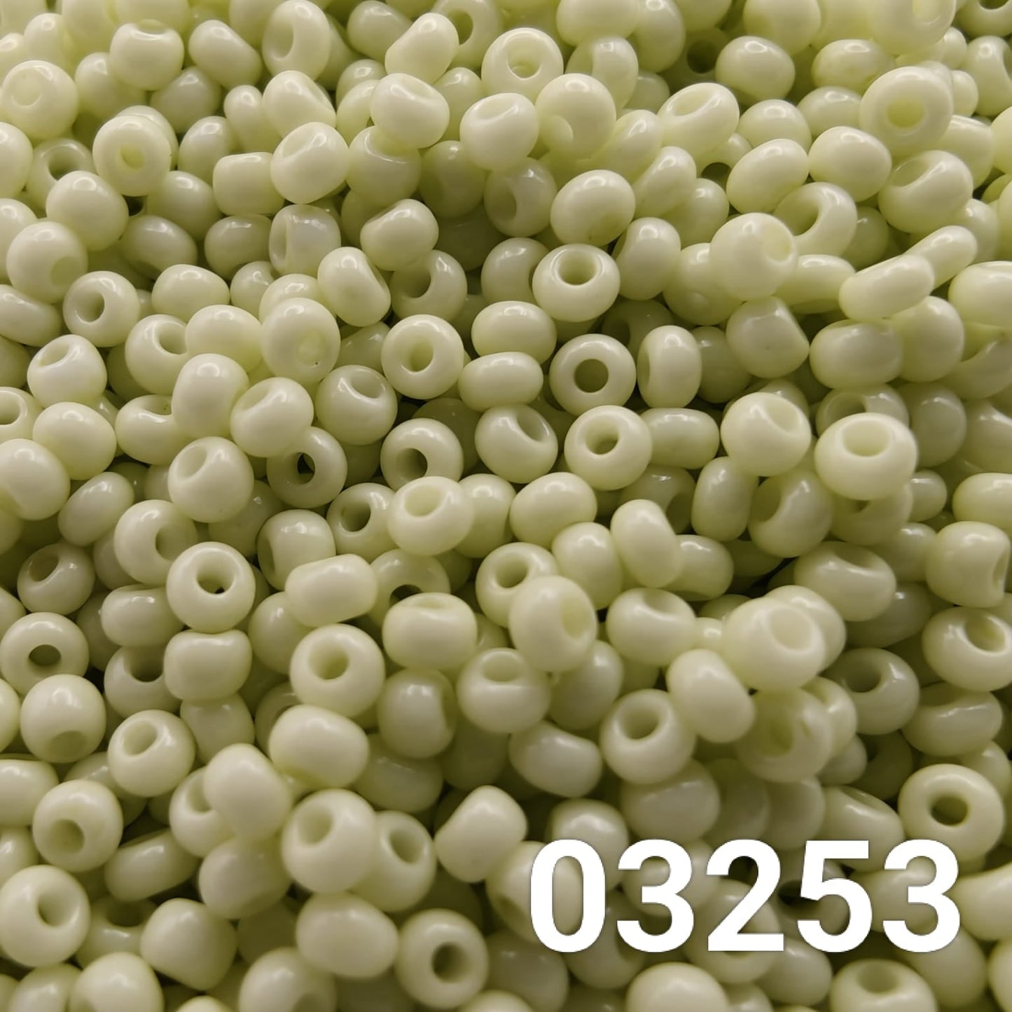 Close-up of Preciosa 10/0 seed beads in Solgel Chalk Yellow-Green color (03253)