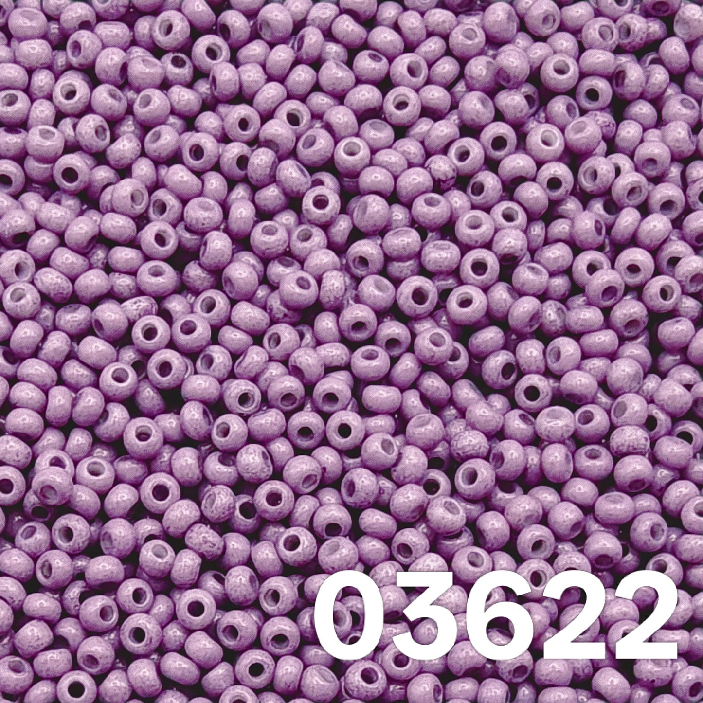 Close-up of Preciosa 10/0 Czech seed beads — Solgel Chalk Violet (03622), glossy violet