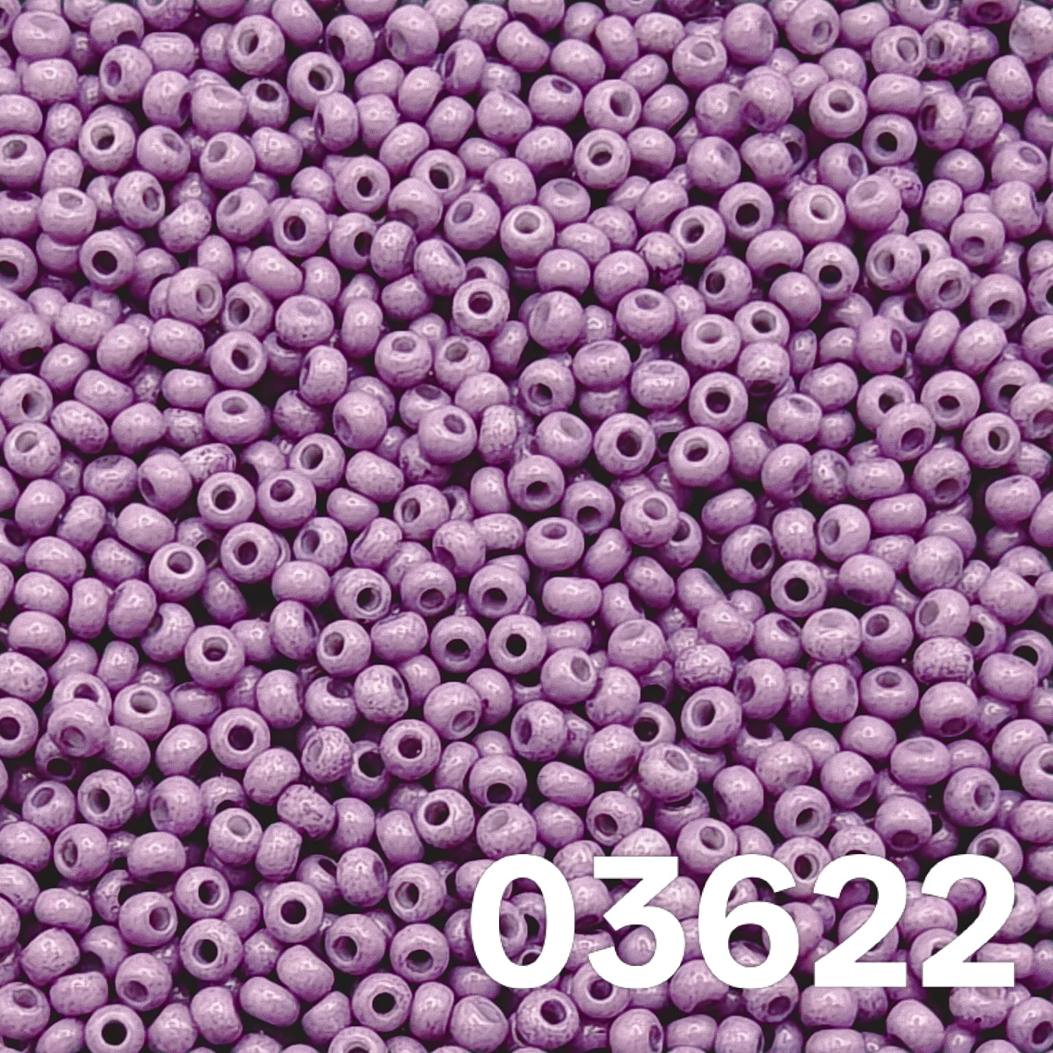 Close-up of Preciosa 10/0 Czech seed beads — Solgel Chalk Violet (03622), glossy violet