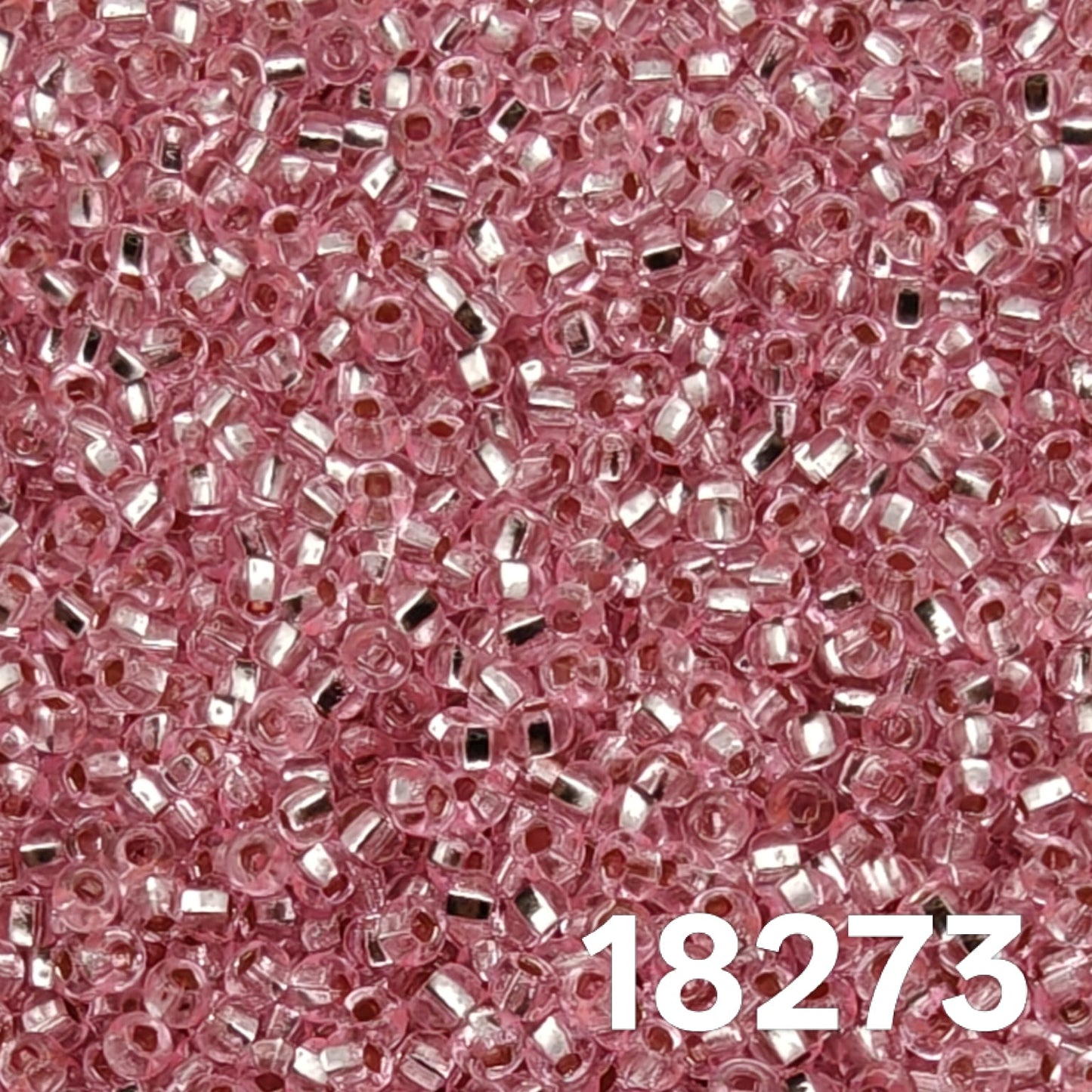 Close-up of Preciosa 10/0 Silverlined Dyed Pink seed beads code 18273, sparkling Czech glass