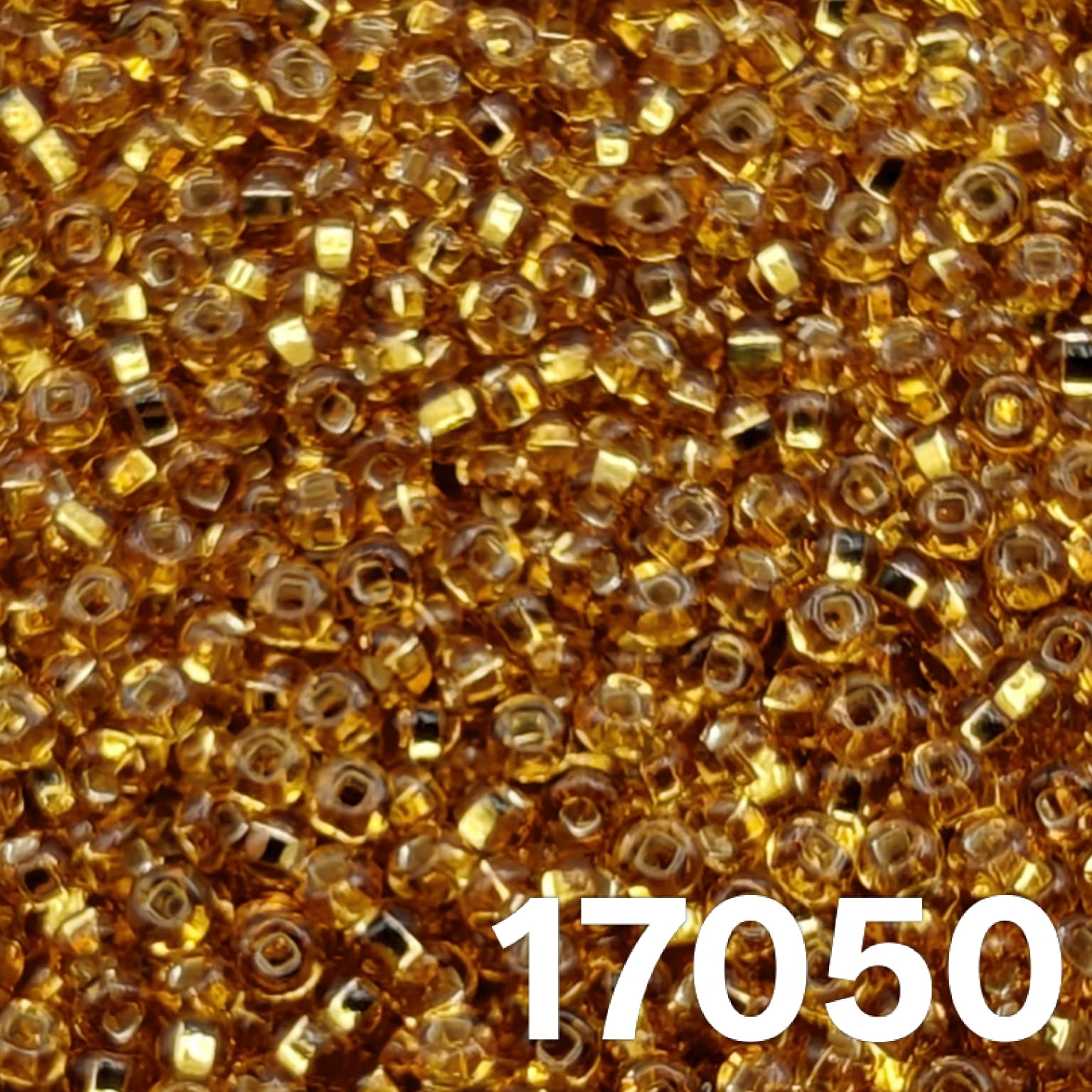 Close-up of Preciosa 10/0 silverlined dark gold (topaz) seed beads, code 17050.