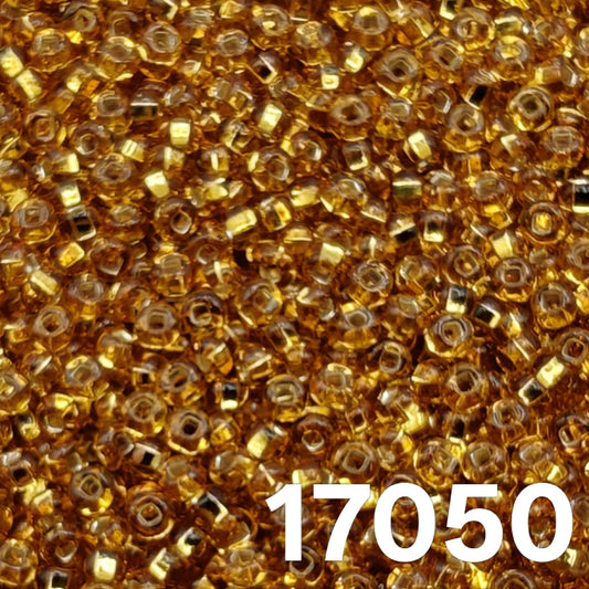 Close-up of Preciosa 10/0 silverlined dark gold (topaz) seed beads, code 17050.