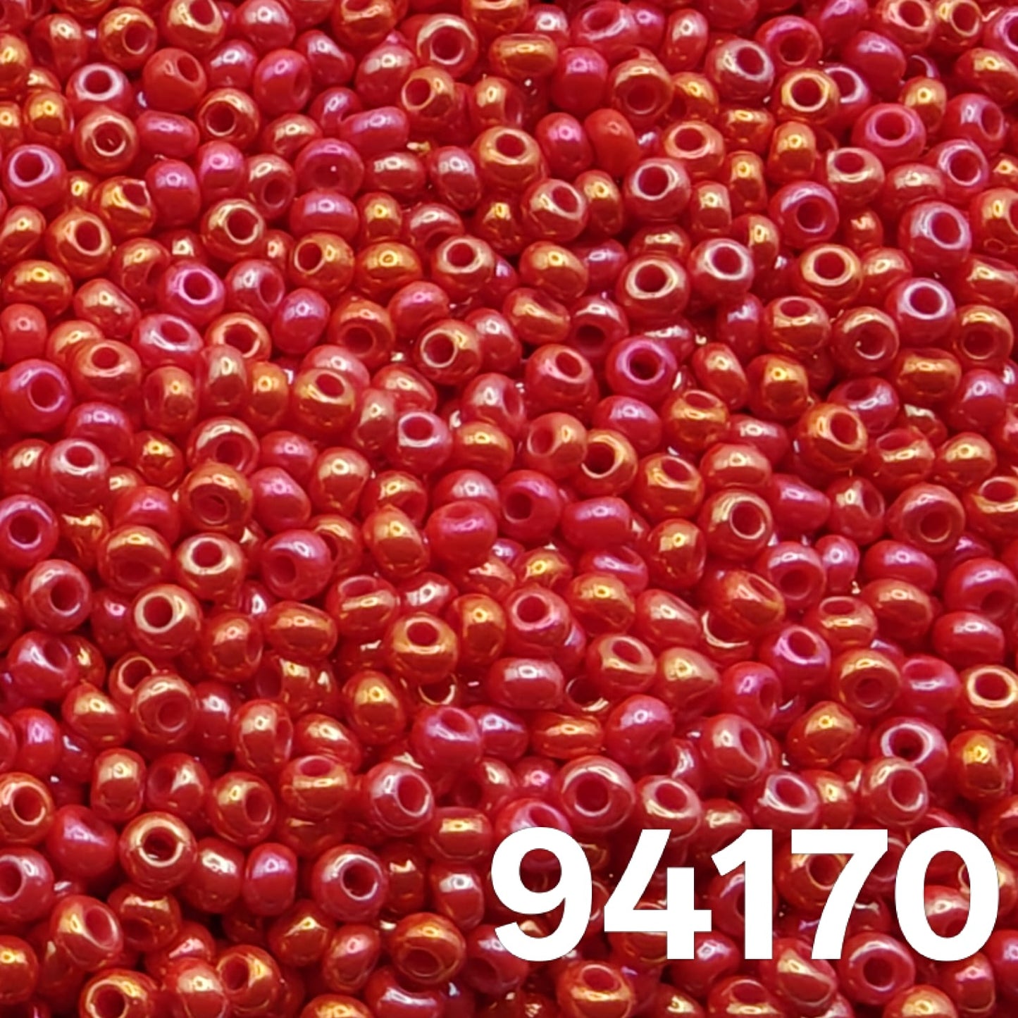 Close-up of Preciosa Czech seed beads 10/0, Opaque Rainbow Light Red 94170 with rainbow sheen