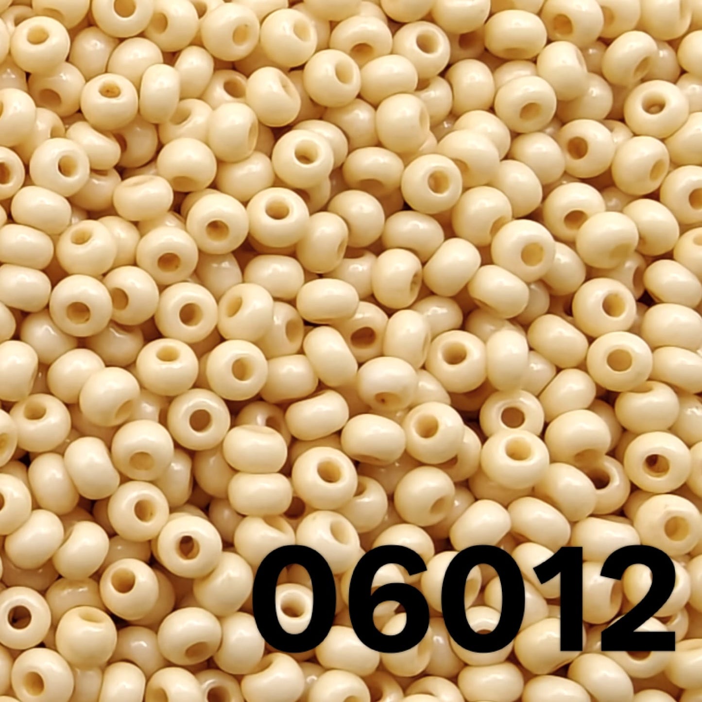 Close-up of round Czech seed beads 10/0 opaque Bone ivory shade 06012