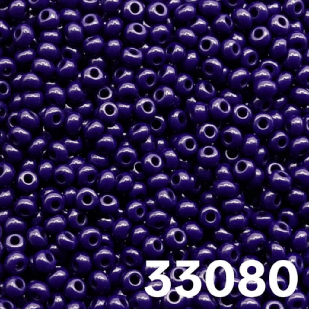 Close up of round opaque dark blue Czech seed beads size 10/0 colour 33080