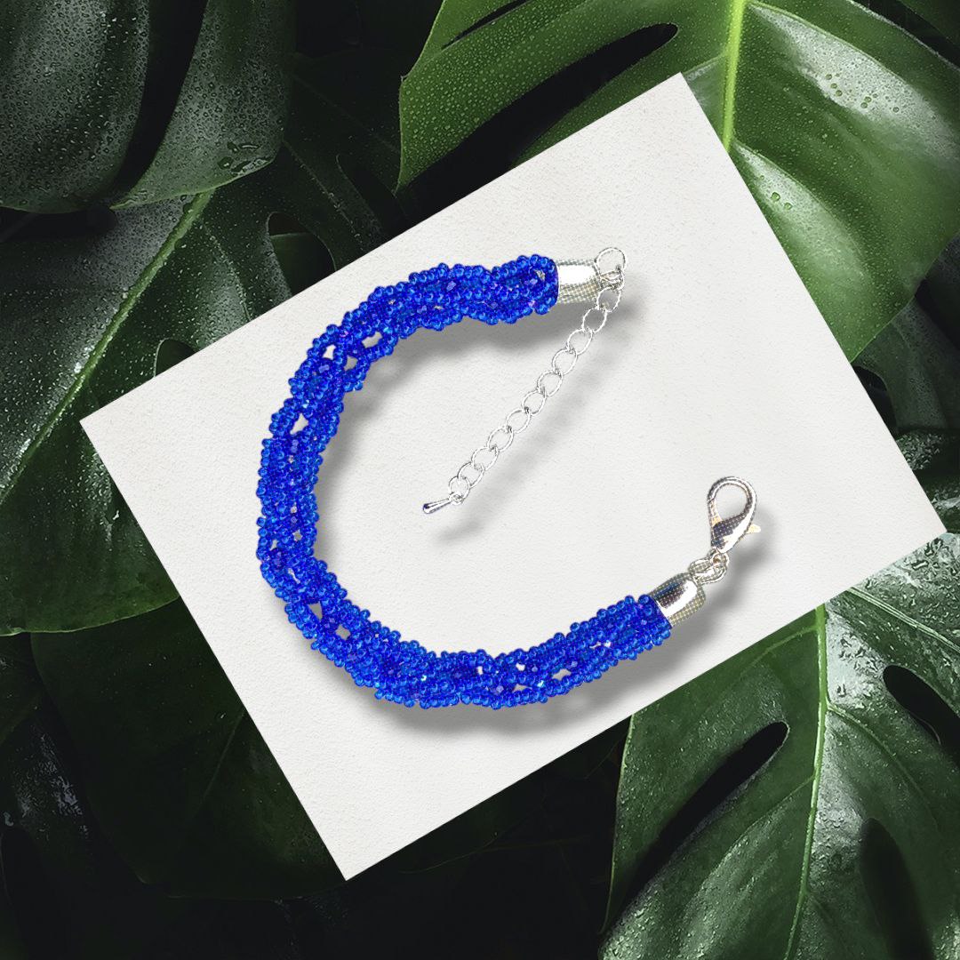 Cobalt beaded rope bracelet with extender, flat lay