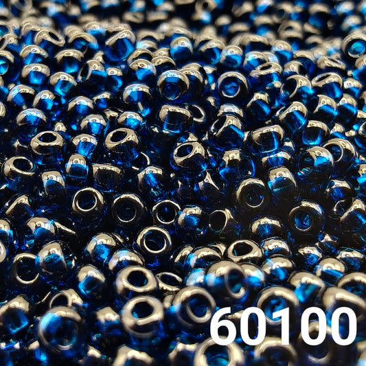 Close-up of PRECIOSA Czech round seed beads 10/0 in transparent Montana blue, colour code 60100 – polished glass beads with rich deep blue shine