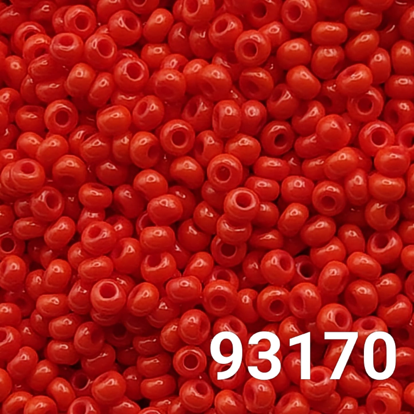Close-up of Preciosa Czech seed beads 10/0 in opaque light red, colour code 93170