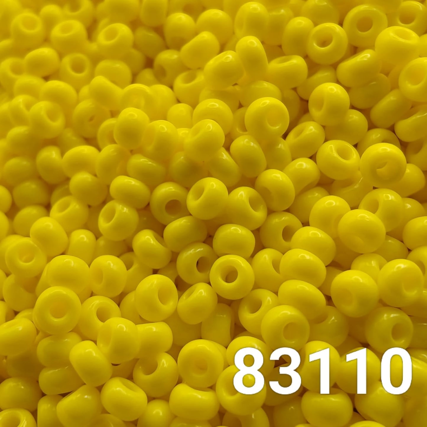 Close-up of Preciosa Czech seed beads 10/0 in opaque light yellow color 83110