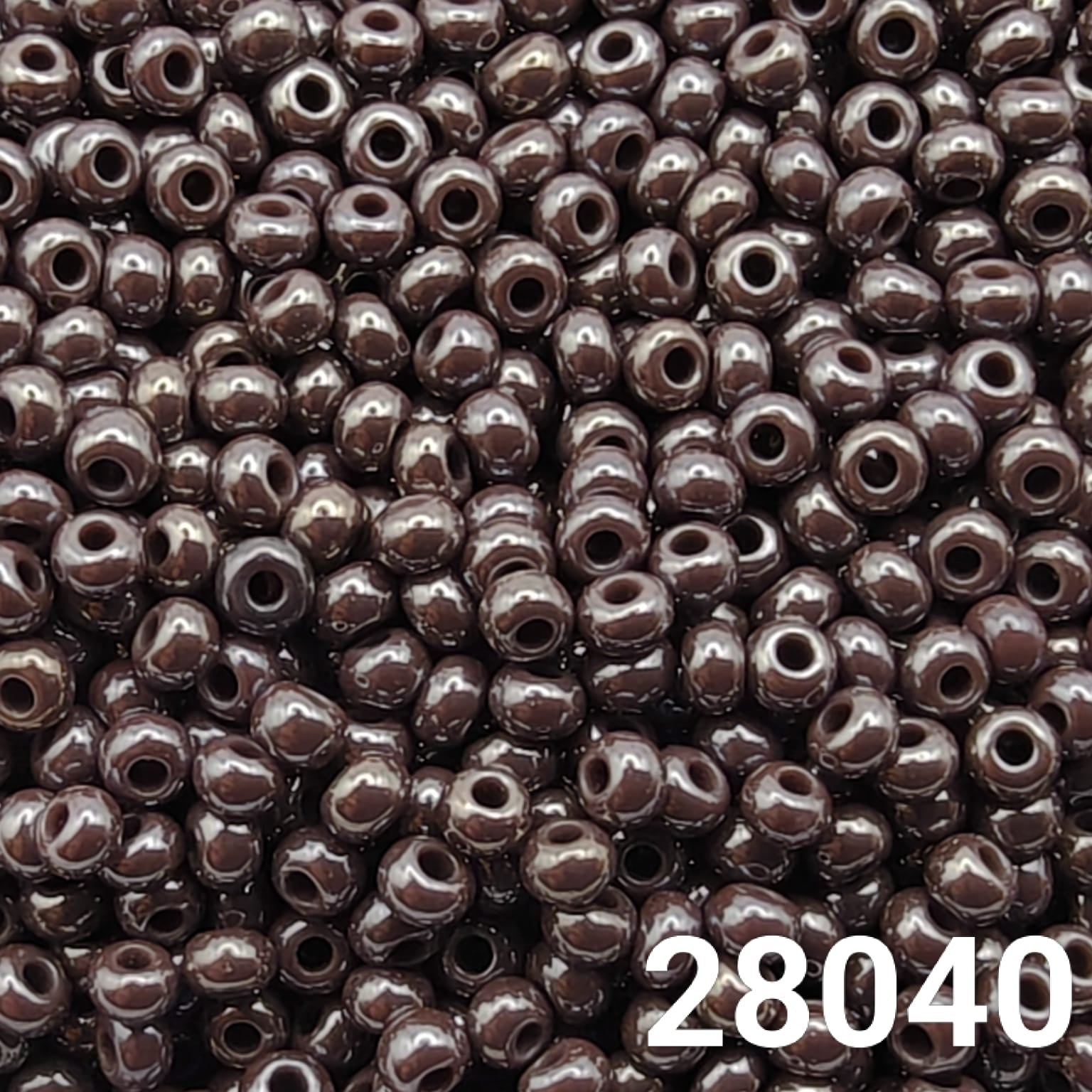 Close-up of round size 10/0 dark mauve luster seed beads by Preciosa