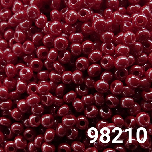 Close-up of Preciosa 10/0 seed beads in opaque luster dark red color (98210)