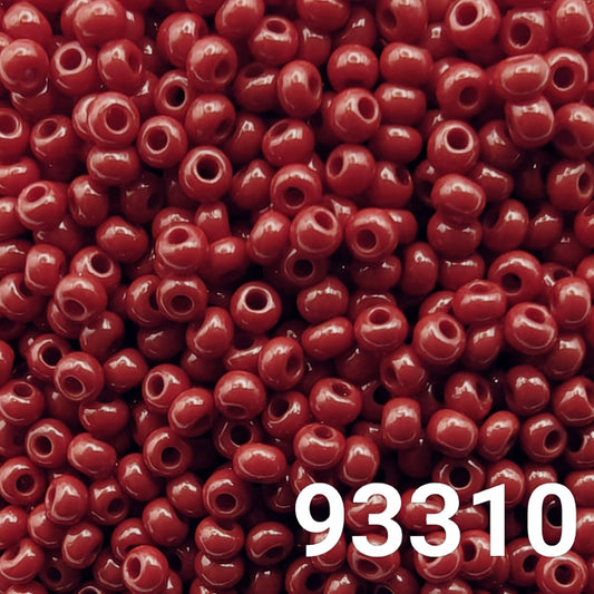 Close-up of Preciosa Czech seed beads 10/0 in opaque dark coral red color 93310