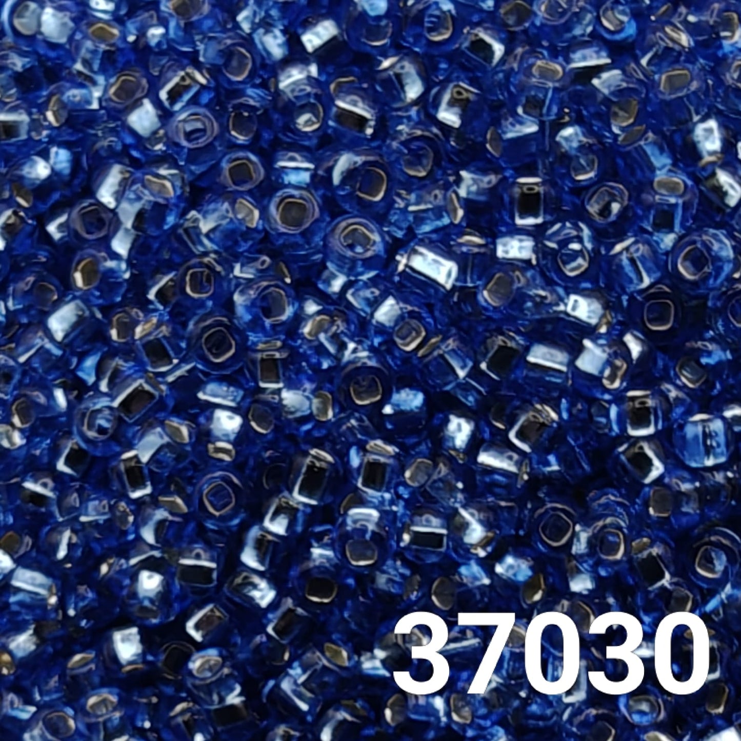 Close-up of Preciosa 37030 sapphire blue silverlined Czech seed beads size 10/0