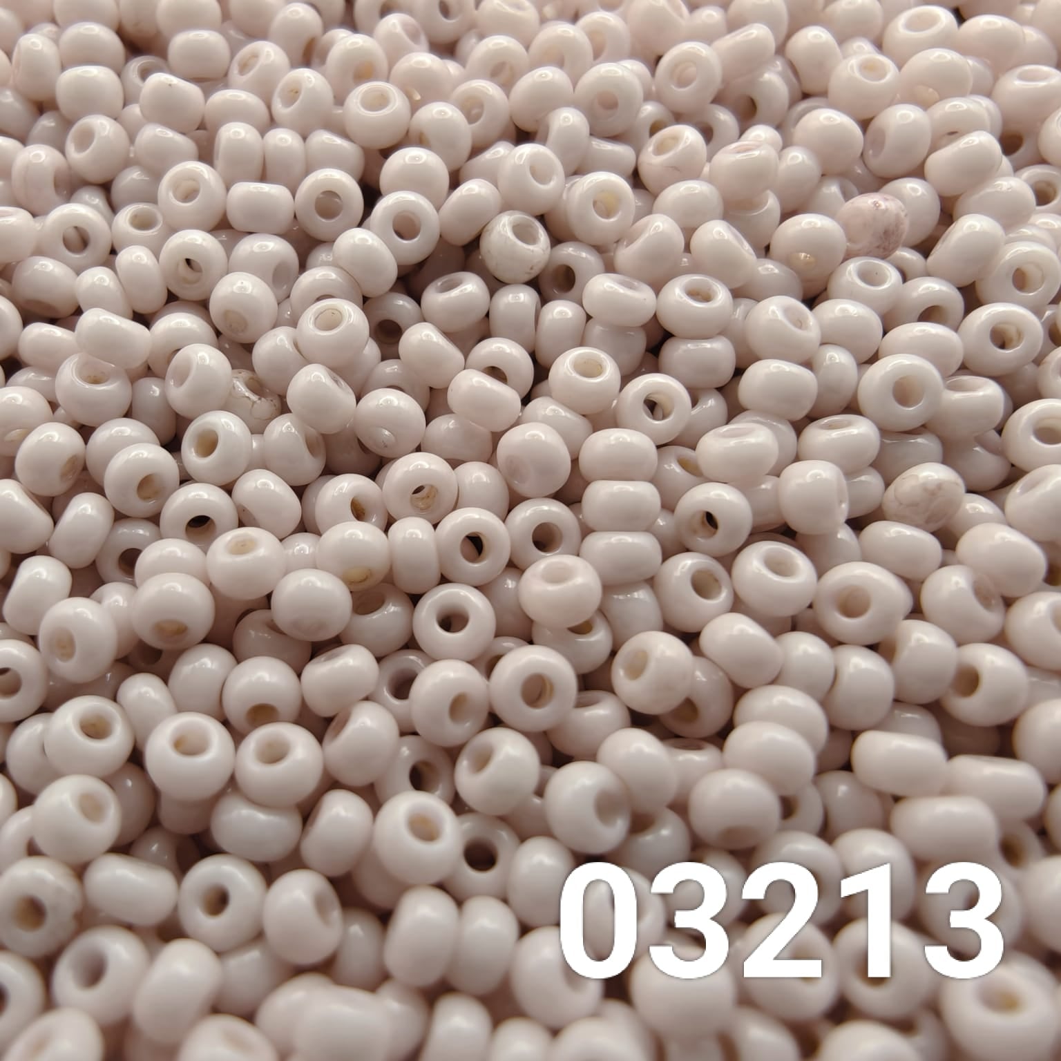 Close-up of Preciosa 10/0 seed beads in Solgel Chalk Lavender Fog color (03213)