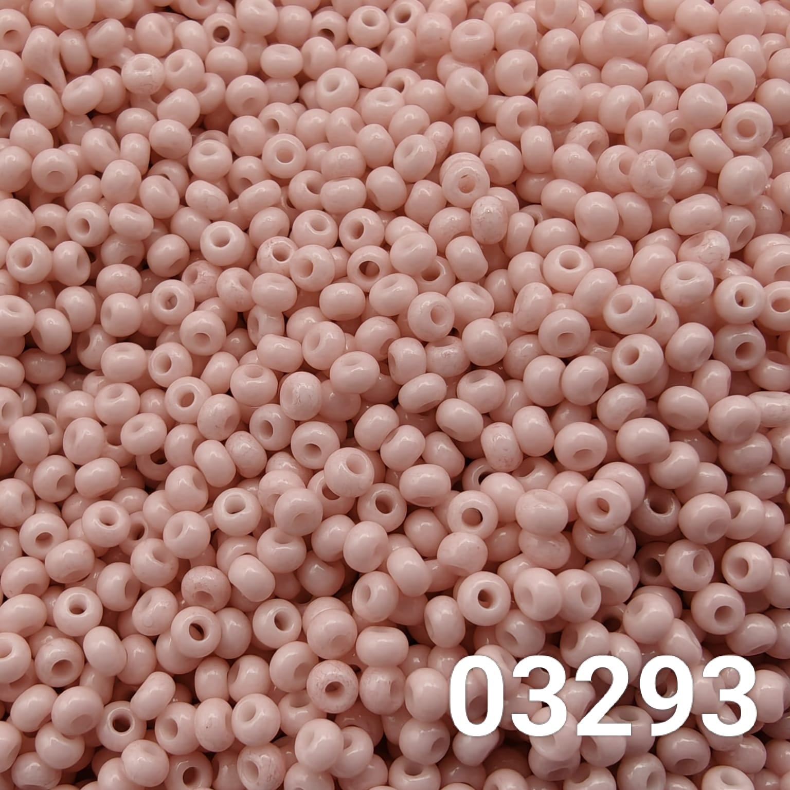 Close-up of Preciosa 10/0 seed beads in Solgel chalk pink color (03293)