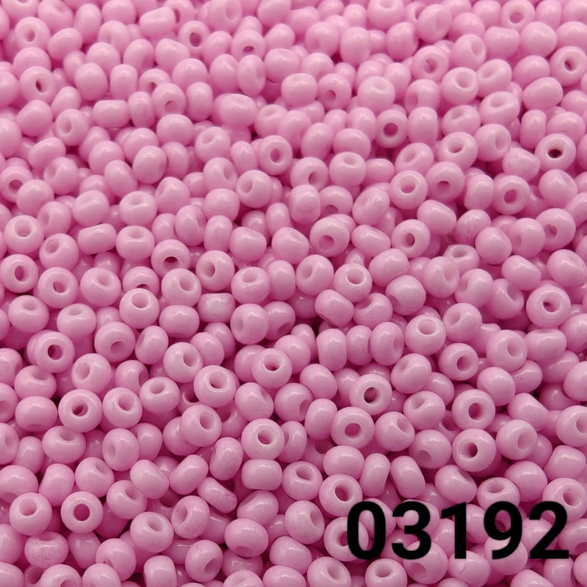 Close-up of Preciosa 10/0 seed beads in Solgel Dyed Tulipian Pink color (03192)