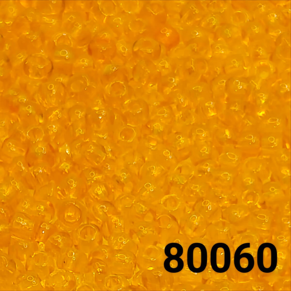 Close-up of PRECIOSA Czech seed beads 10/0 in transparent orange, colour code 80060
