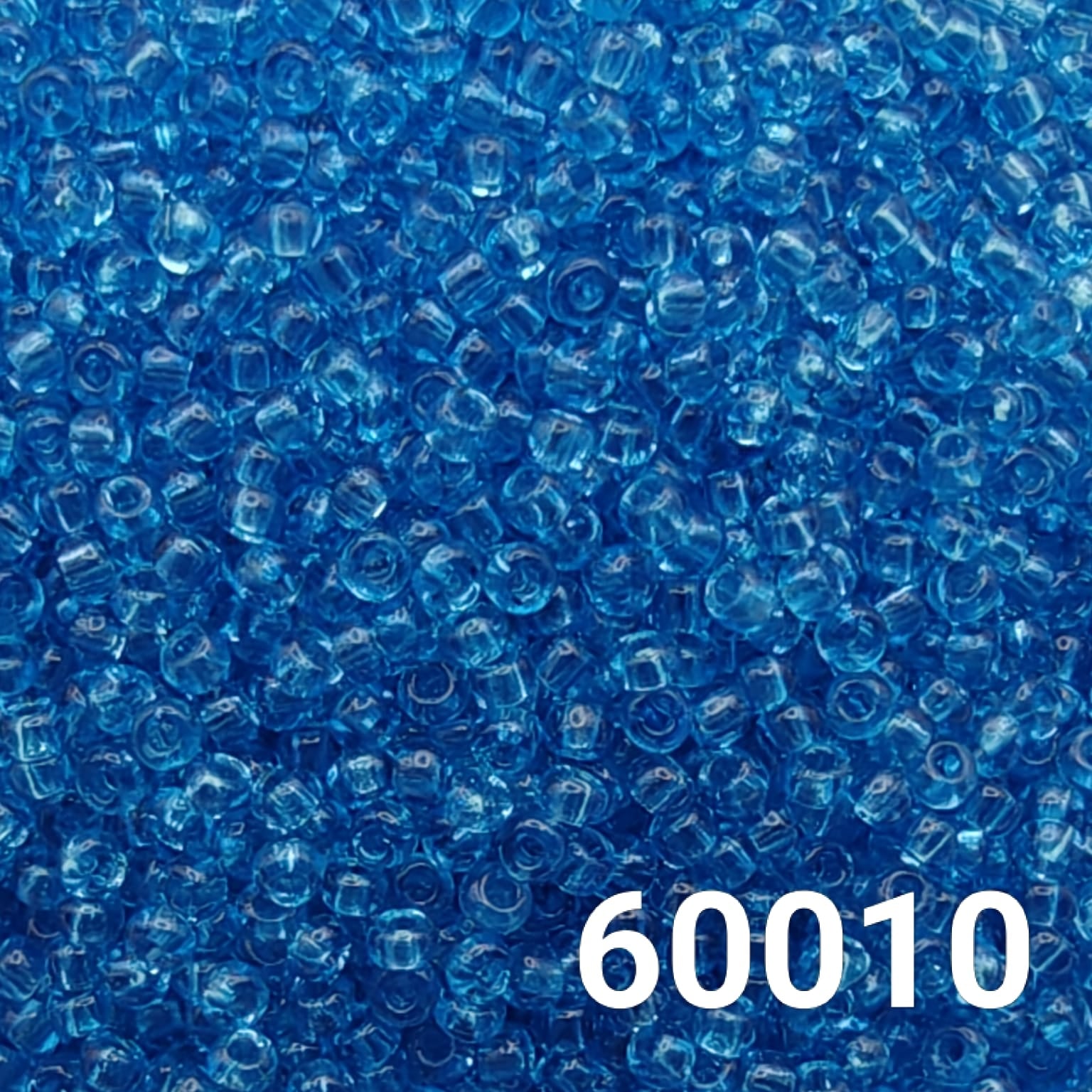 Close-up of Preciosa 10/0 Light Aquamarine transparent seed beads, code 60010.