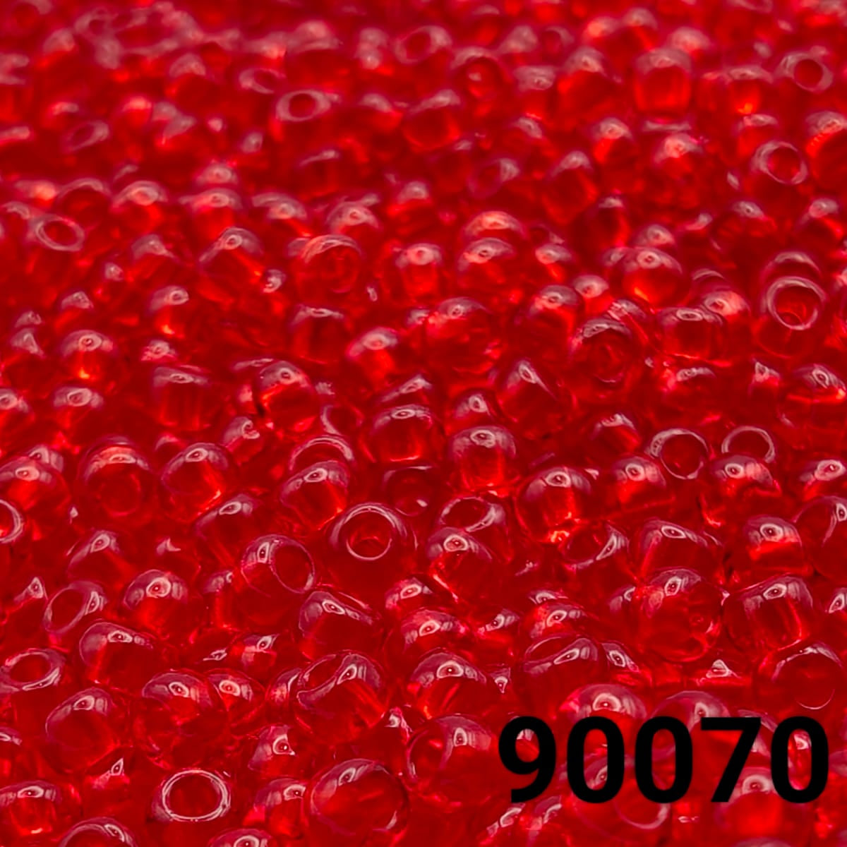 Close-up of PRECIOSA Czech 10/0 seed beads in transparent red, colour code 90070