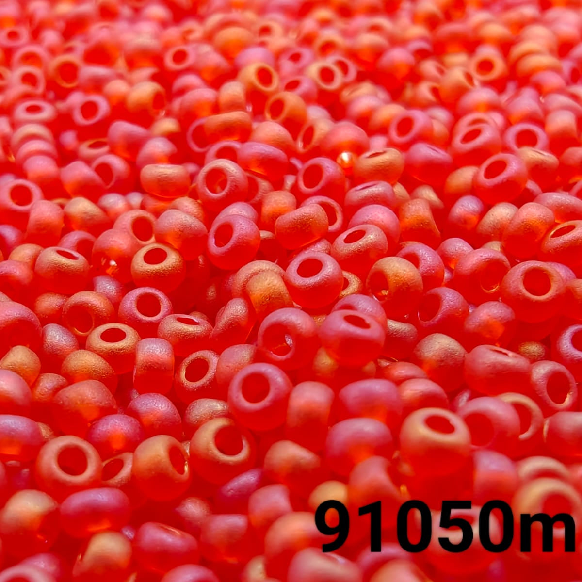 Close-up of PRECIOSA 10/0 matte transparent red seed beads with rainbow AB finish, colour code 91050m – round frosted Czech glass beads