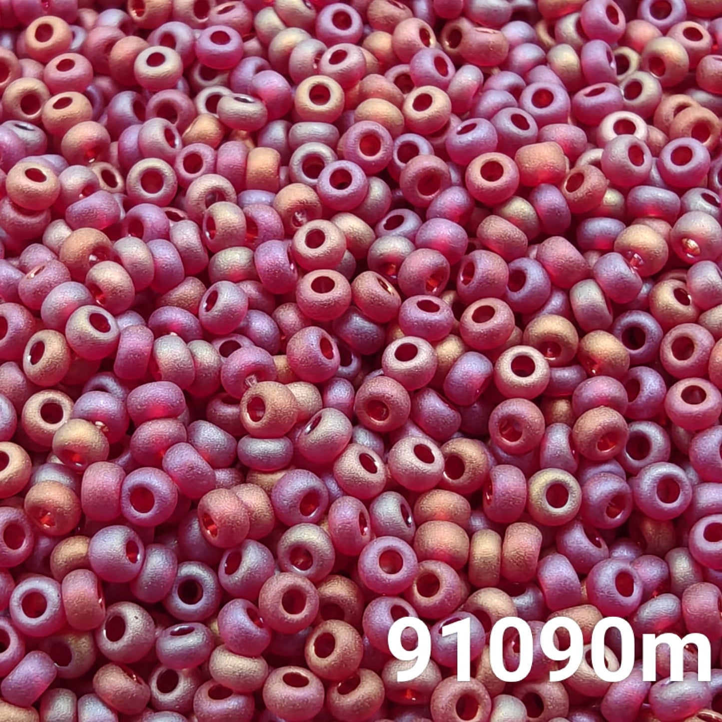 Close-up of Preciosa 10/0 seed beads in transparent matt ruby AB color (91090m)