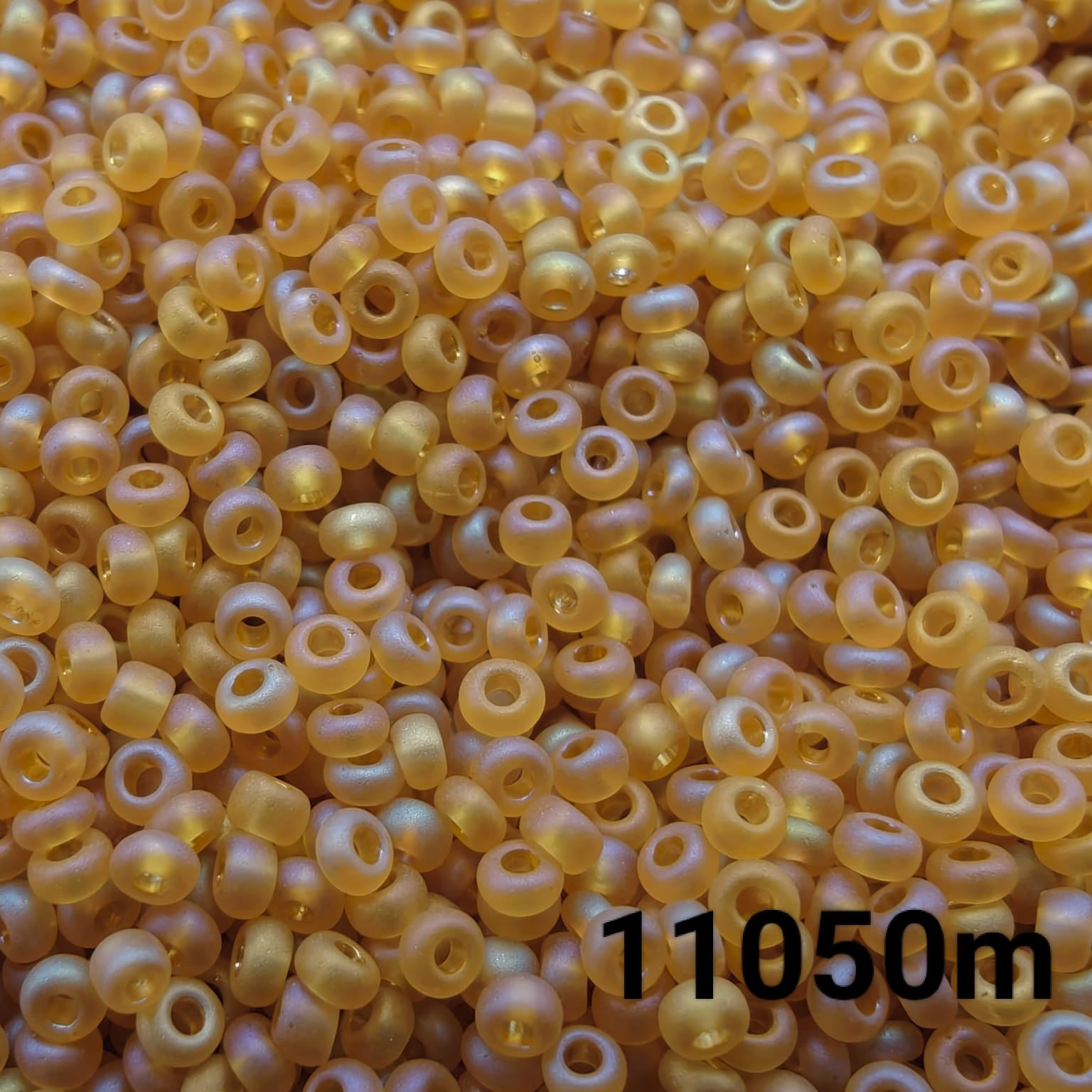 Close-up of Preciosa 10/0 seed beads in Transparent Matt Topaz AB color (11050m)