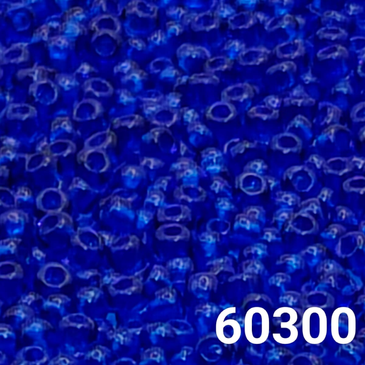 Close-up of PRECIOSA Czech seed beads 10/0 in transparent navy blue, colour code 60300 – polished round glass beads