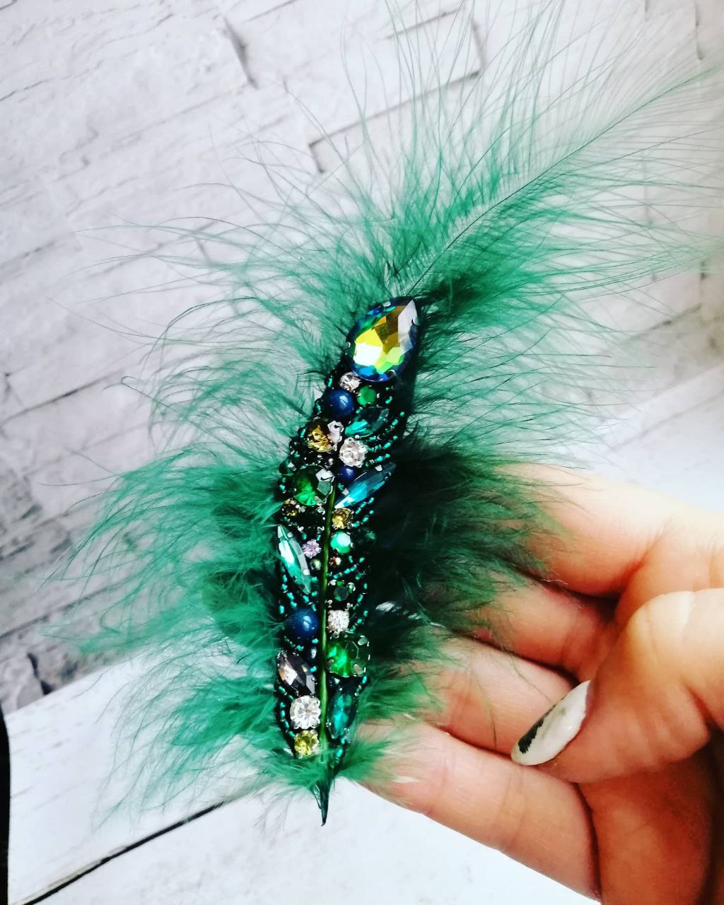 “Emerald Feather” brooch with green and blue gemstones