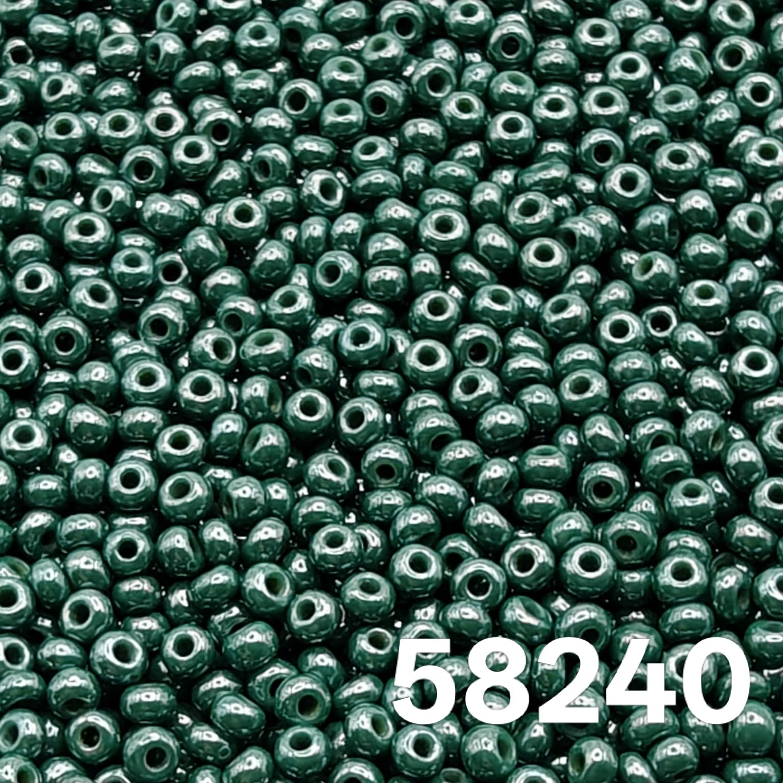 Macro close-up of Preciosa 10/0 Opaque Luster Dark Green (58240) round seed beads — deep evergreen, glossy luster, Czech glass.