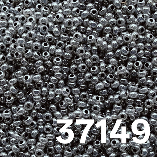 Macro close-up of Preciosa 10/0 Pearlized Grey Ceylon (37149) round seed beads — cool dove-grey with satin ceylon luster, Czech glass.