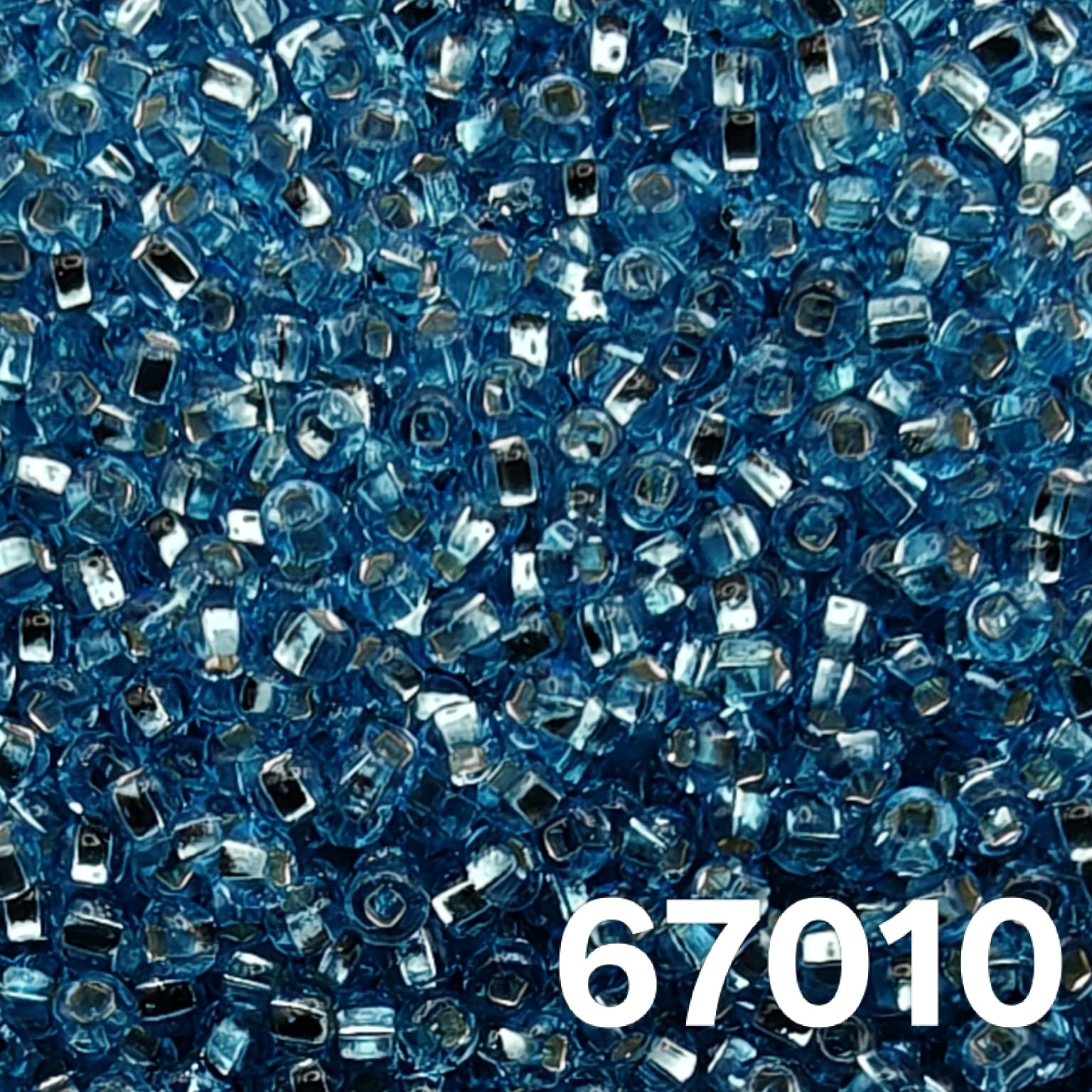 Macro of Preciosa 10/0 Silverlined Aqua seed beads, code 67010—bright aqua blue glass with reflective silver cores