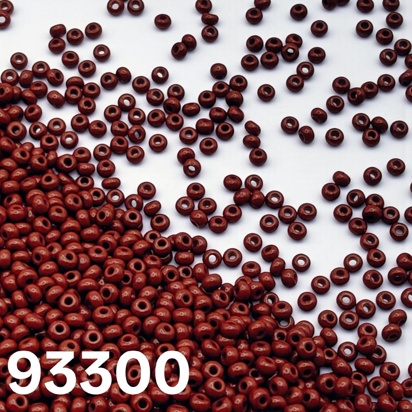 Macro view of Czech glass seed beads Preciosa 10/0 opaque dark red colour 93300
