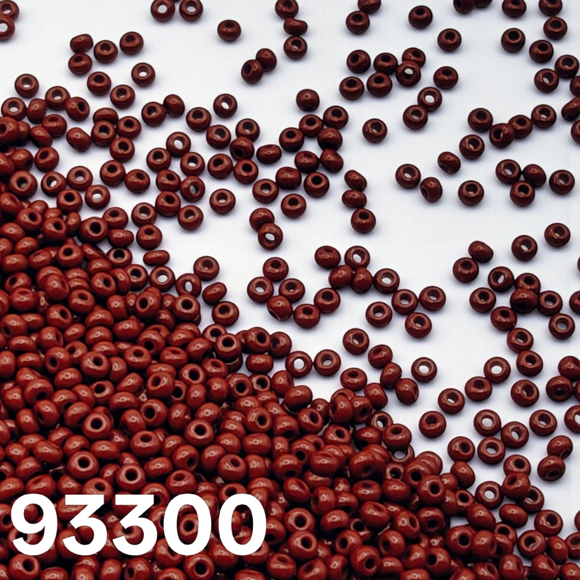 Macro view of Czech glass seed beads Preciosa 10/0 opaque dark red colour 93300