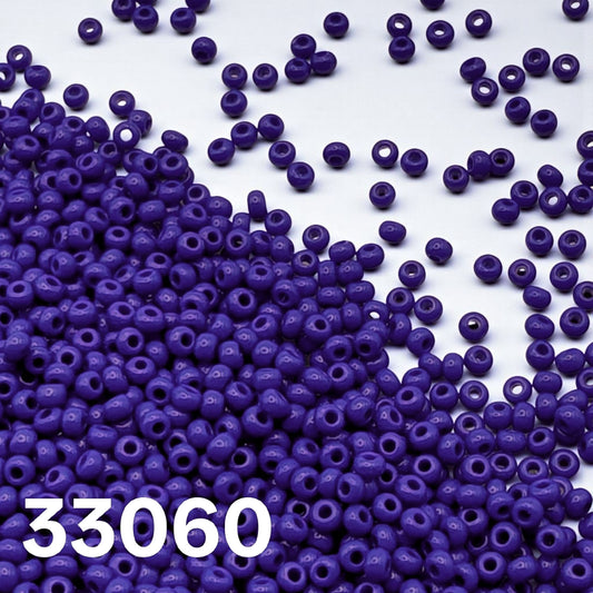 Opaque Dark Blue 10/0 seed beads 33060 spilled on white background