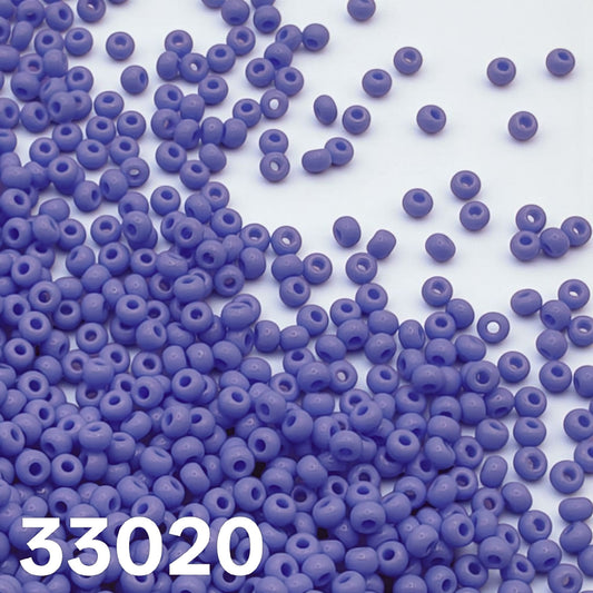 Opaque powder blue Czech seed beads 10/0 33020 scattered on white background