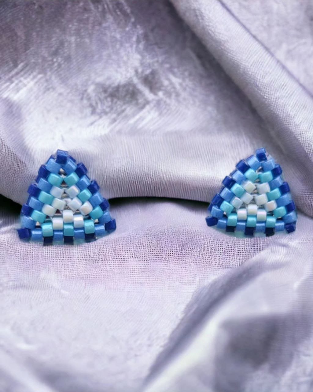 Pair of aqua and white seed bead triangle studs on a clean background