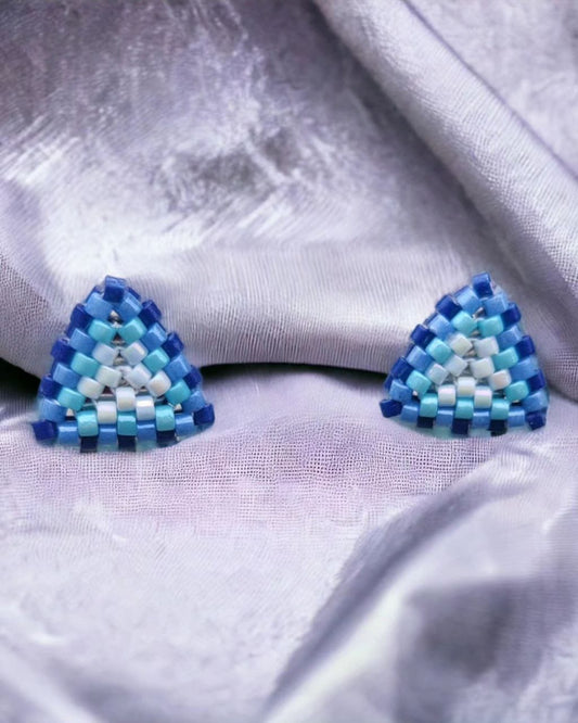 Pair of aqua and white seed bead triangle studs on a clean background