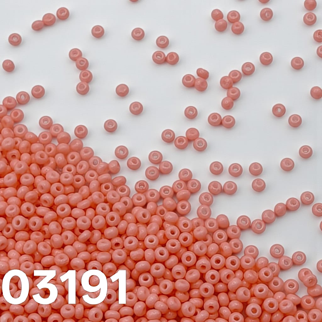 Preciosa 10/0 Czech seed beads - Solgel Chalk Coral Pink 03191, loose beads on white background