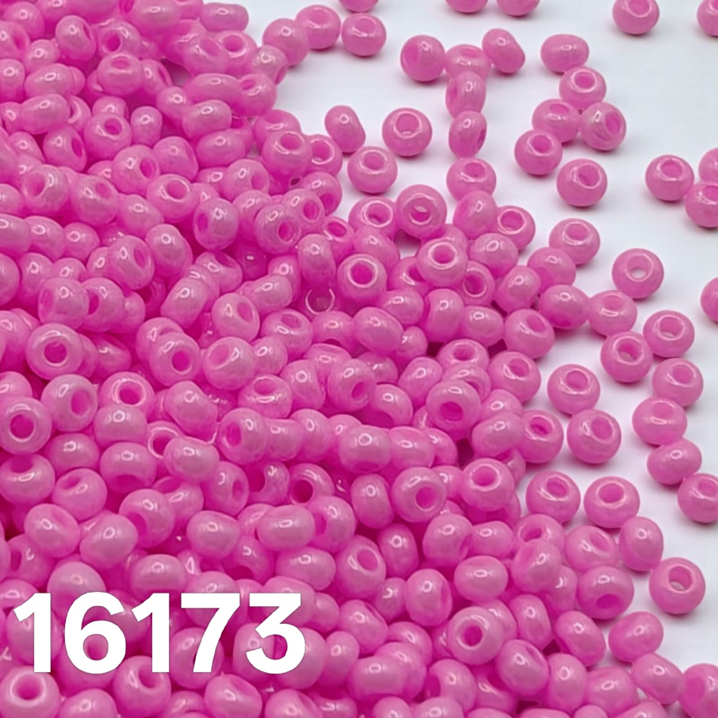 Preciosa 10/0 Opaque Dyed Chalk Pink 16173 seed beads — macro close-up of glossy round beads.