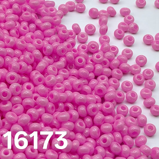 Preciosa 10/0 Opaque Dyed Chalk Pink 16173 seed beads — macro close-up of glossy round beads.