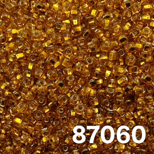 Preciosa 10/0 seed beads 87060, silverlined dark yellow amber, close-up macro