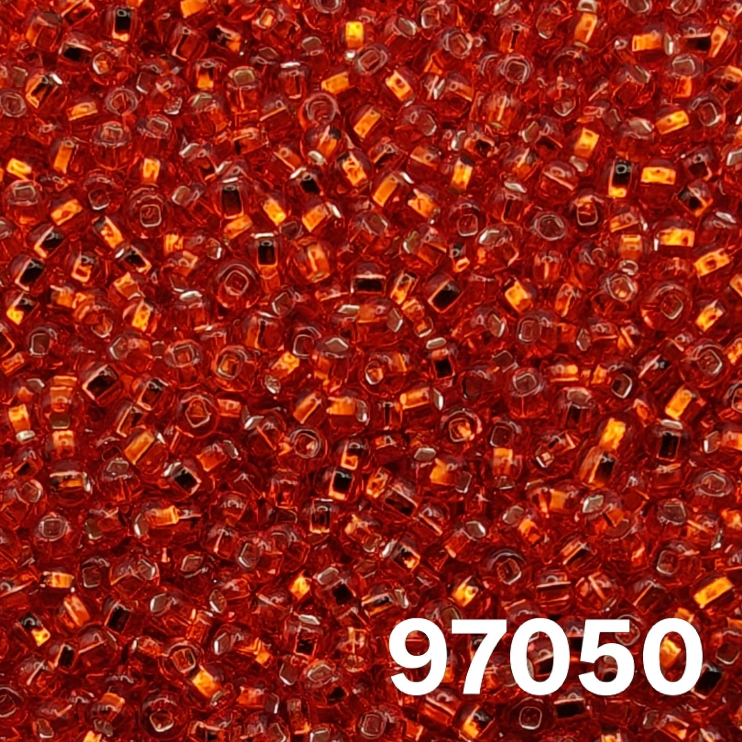 Preciosa 10/0 silverlined light red seed beads, square hole, colour 97050 close-up