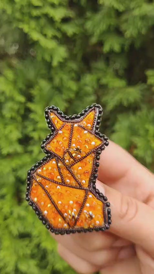 Short clip showing the fox brooch shimmer and secure pin back while moving